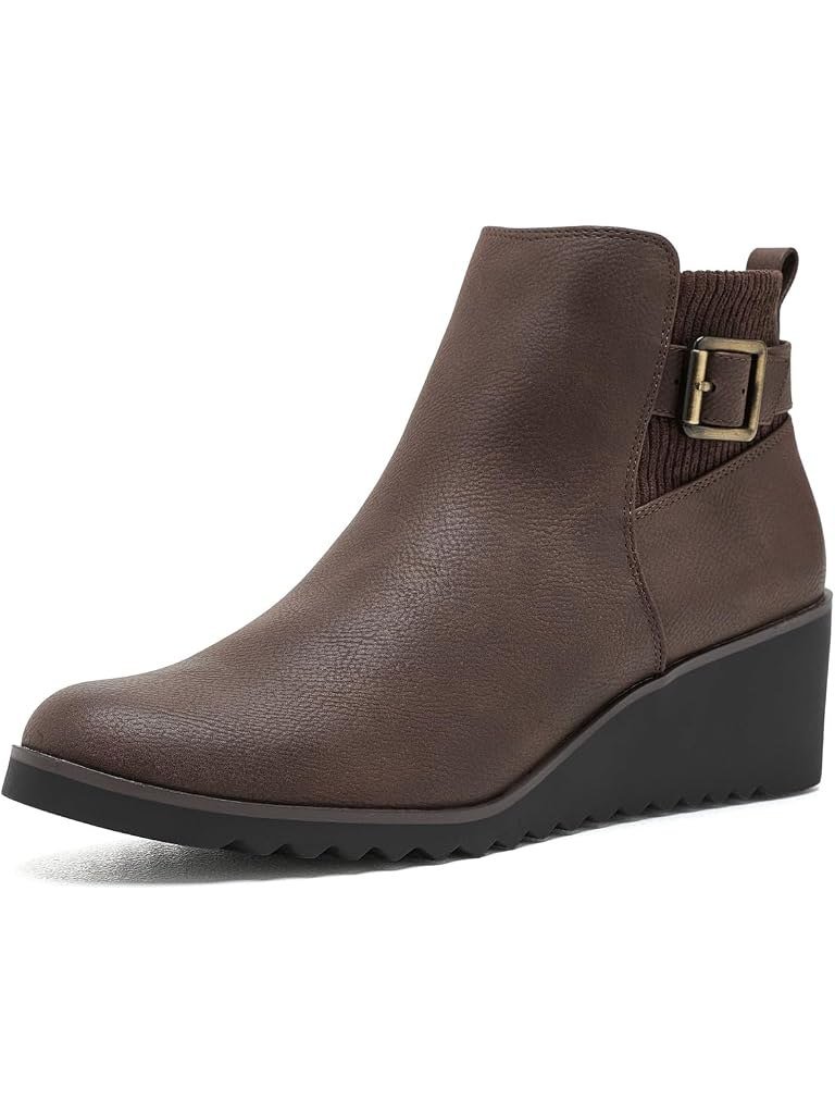 Dark brown wedge ankle boot with a knit back panel and buckle strap, one of the comfortable fall boots women over 50 can walk in all day.