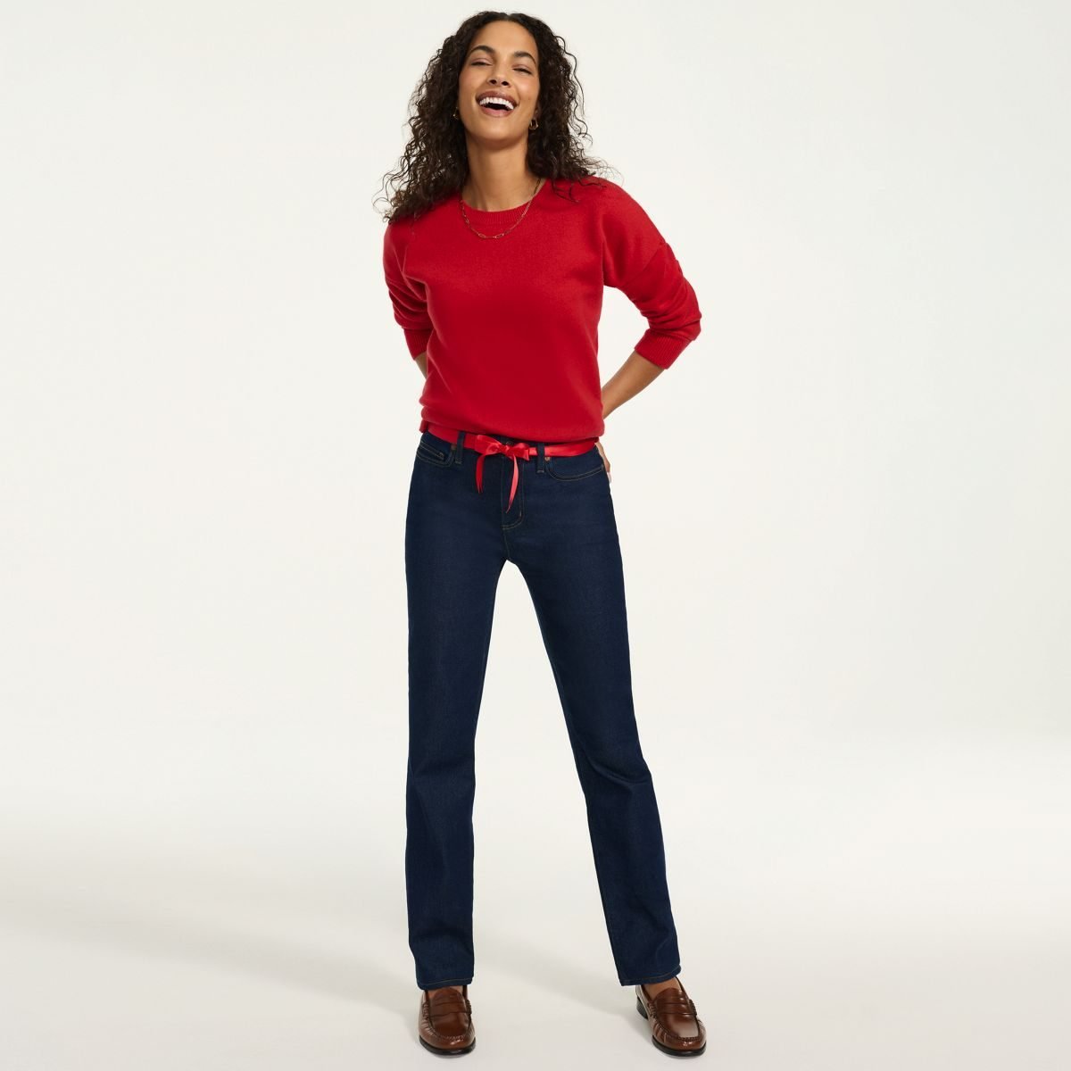 Woman over 50 wearing dark wash high rise straight leg jeans, the first piece of a fall capsule wardrobe women over 50 can wear all season.