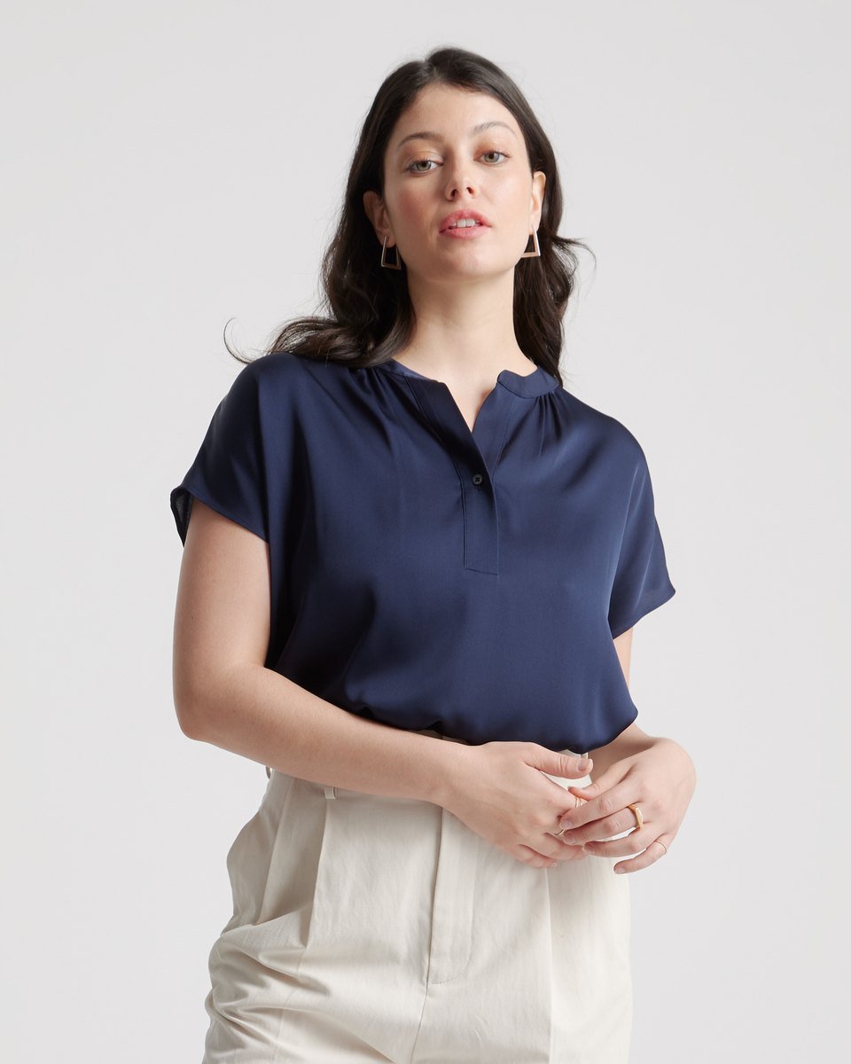 Navy washable silk dolman sleeve blouse from Quince, one of the office party outfits over 50 in this list, with a band collar and short sleeves