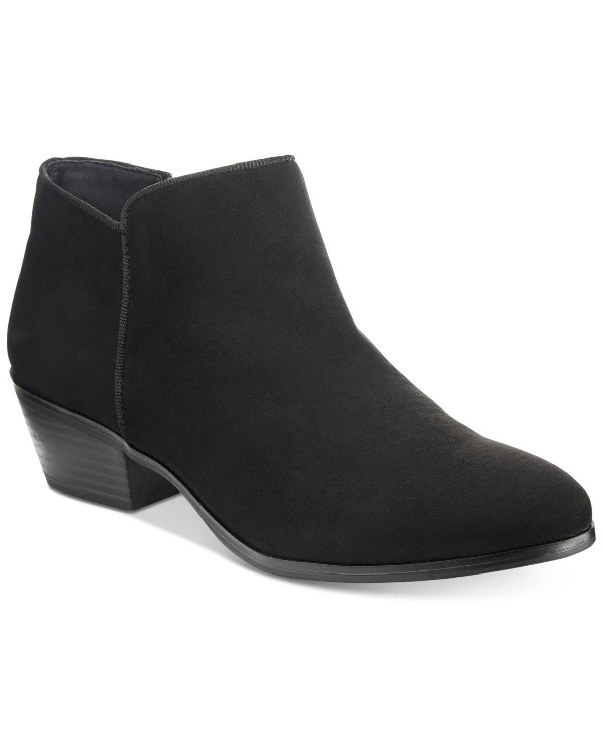 Woman over 50 wearing low heel ankle boots with dark straight leg jeans, a fall capsule shoe.