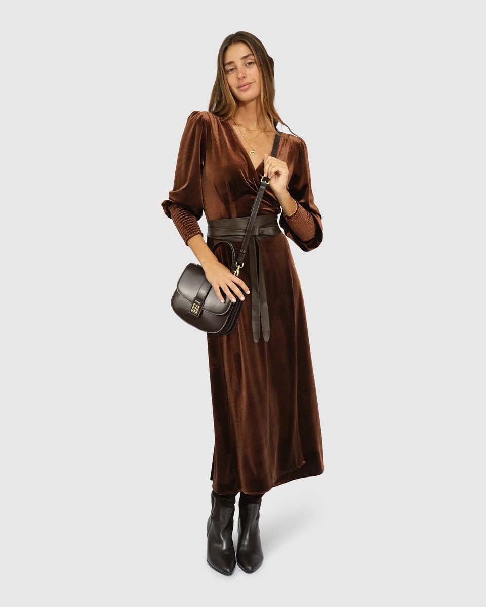 Dark chocolate brown velvet wrap dress with a self tie waist, a holiday party outfit for women over 50.