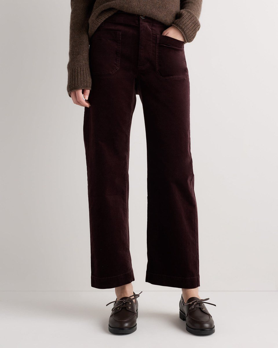 Wide leg velvet pants in deep chocolate plum brown with front patch pockets, worn with a knit top.
