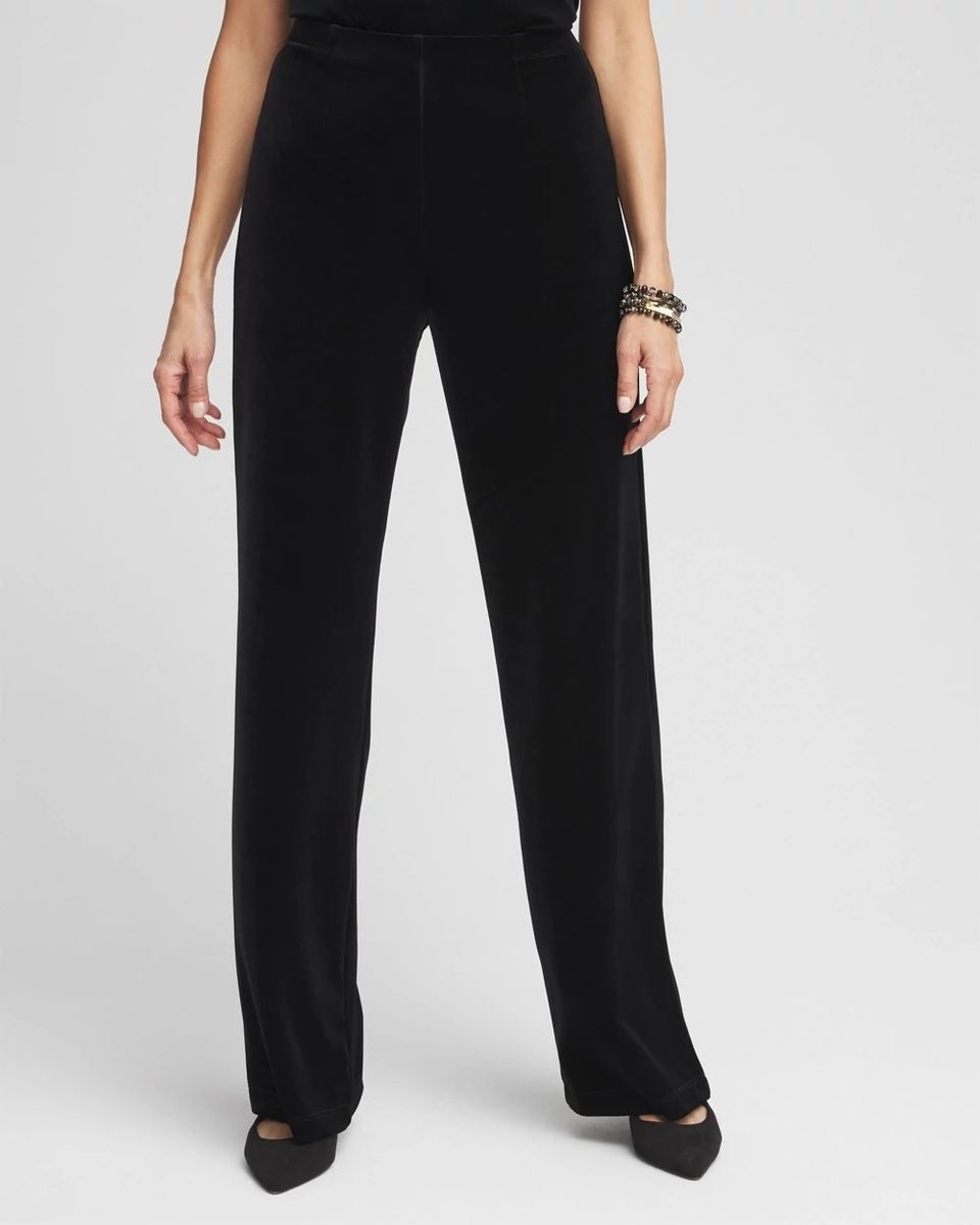 Black velvet pull on trousers with a flat front, worn with a black top and low heels.