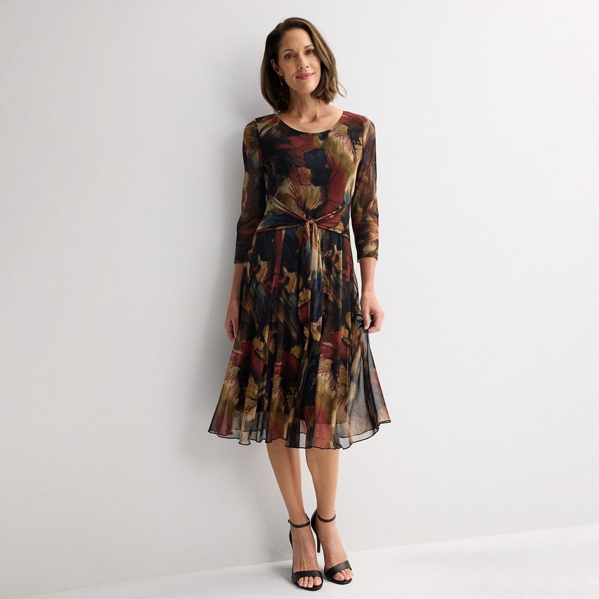 Dark rust and navy printed mesh midi dress with three-quarter sleeves and a tie front waist.