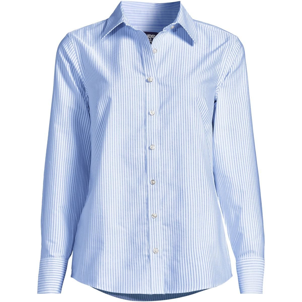 Woman over 50 wearing a blue and white striped Oxford shirt open over a knit top with jeans.