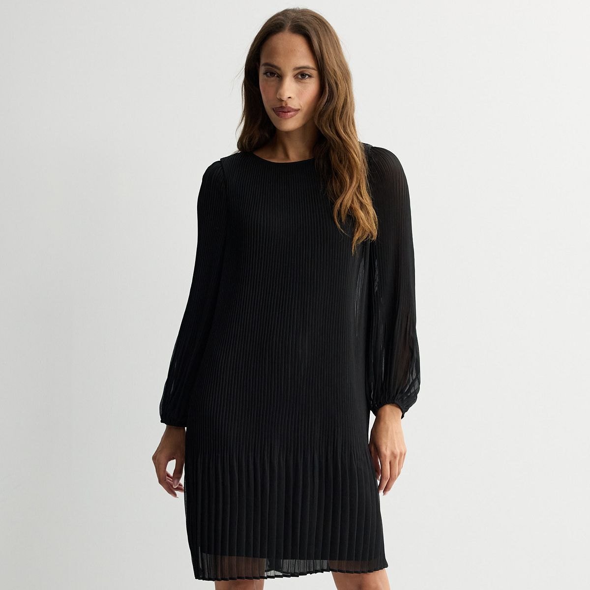 Black pleated chiffon shift dress with long sheer sleeves and a round neck.