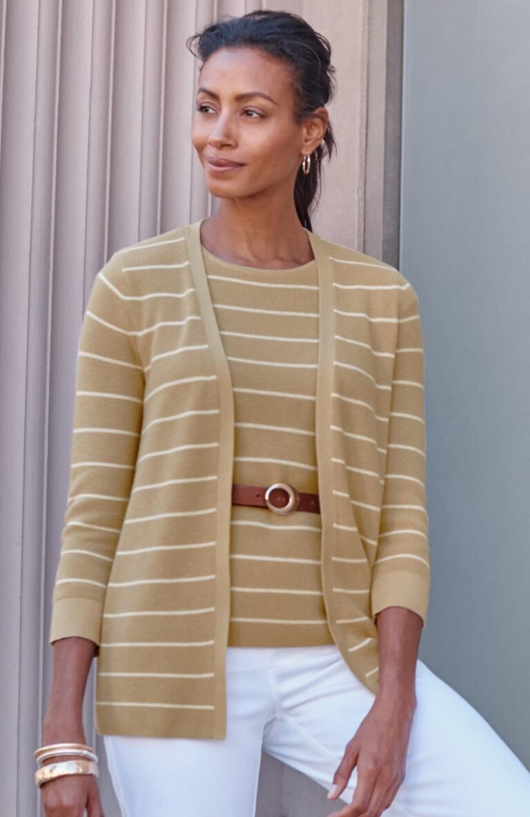 Woman over 50 wearing a long open ribbed cardigan over slim pants, a tummy flattering layered outfit.