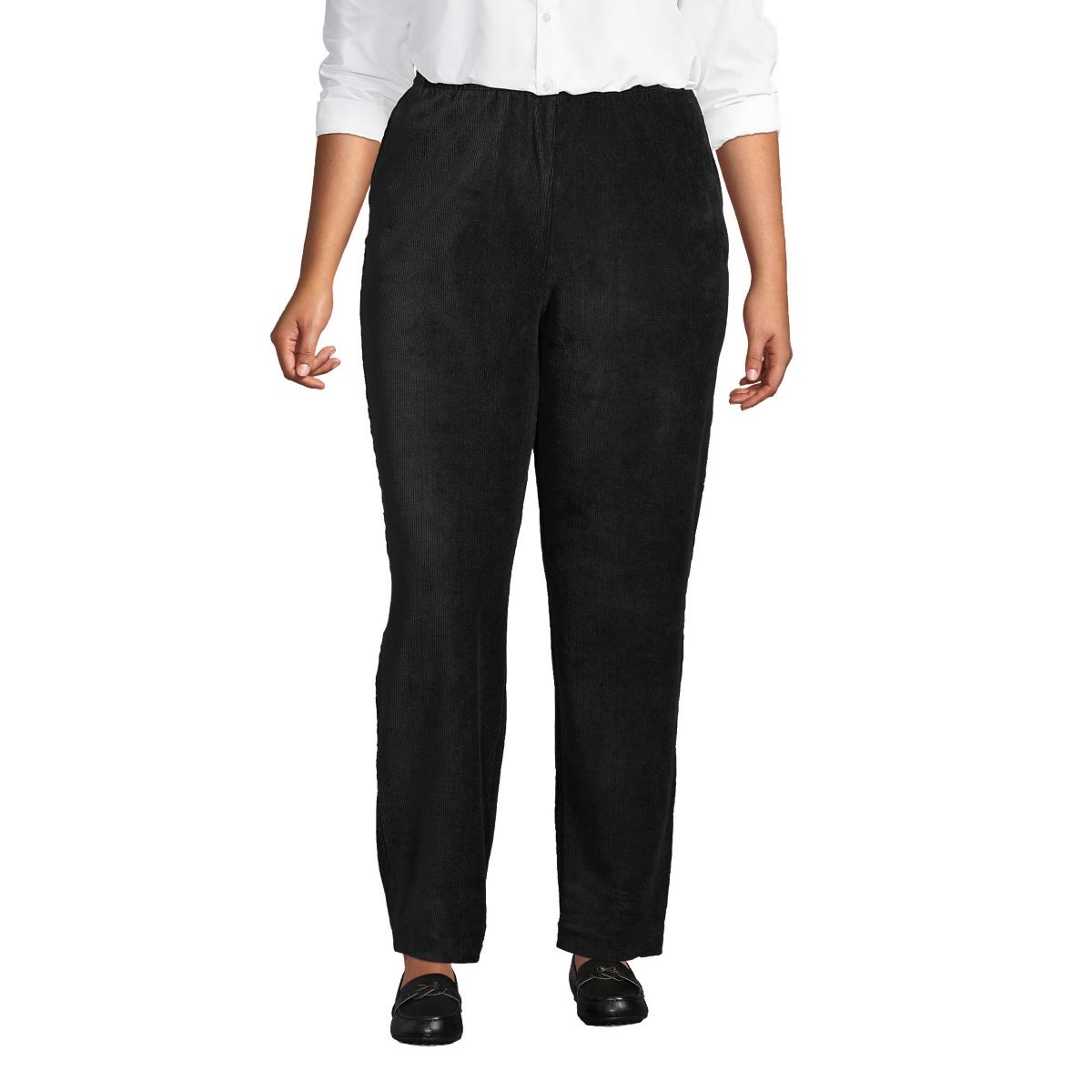 Woman over 50 wearing high rise corduroy pants with a full elastic waist and a long open cardigan, a comfortable Thanksgiving hosting outfit.
