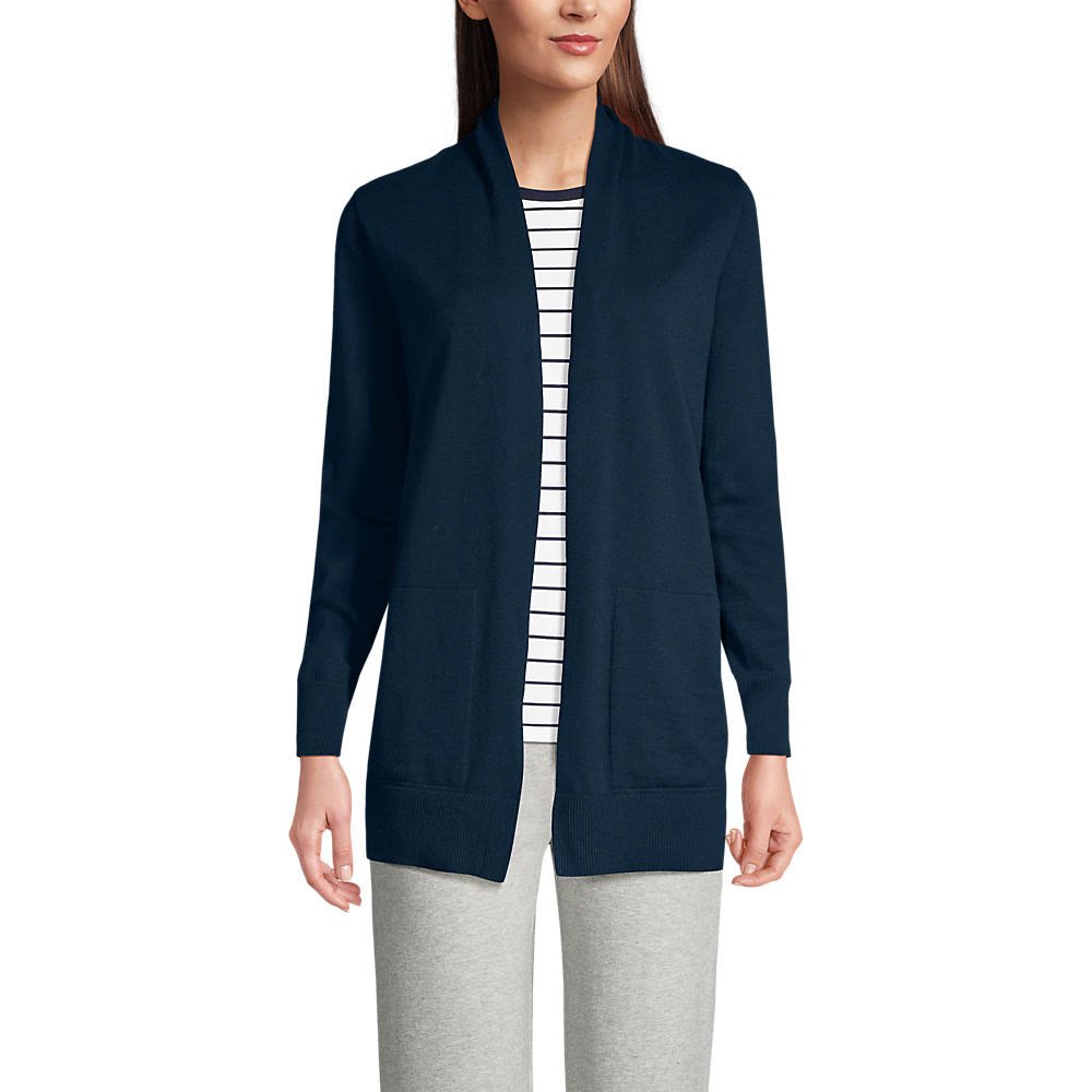 Woman over 50 wearing ponte wide leg pants with a long open cardigan and a statement necklace, a dressy and comfortable Thanksgiving dinner outfit.