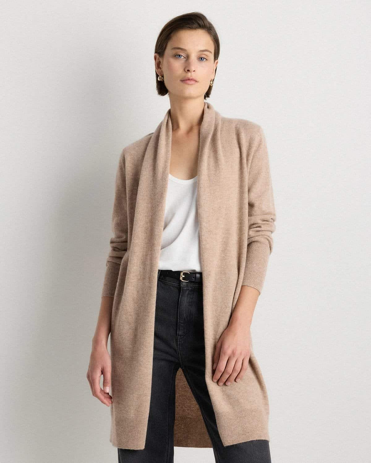 Long cashmere duster cardigan worn open over a simple dress, elegant vertical framing for a tummy over 50.