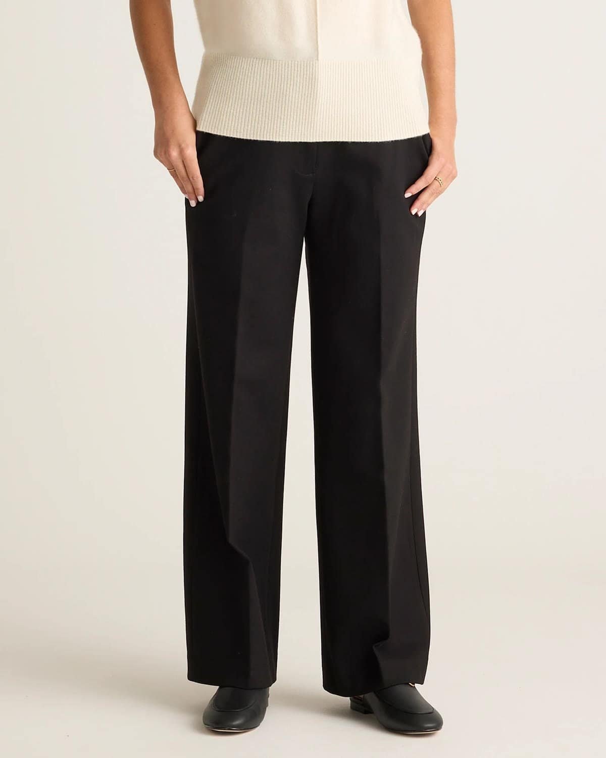 One color column outfit with black ponte trousers and a black top, a sleek tummy flattering look over 50.