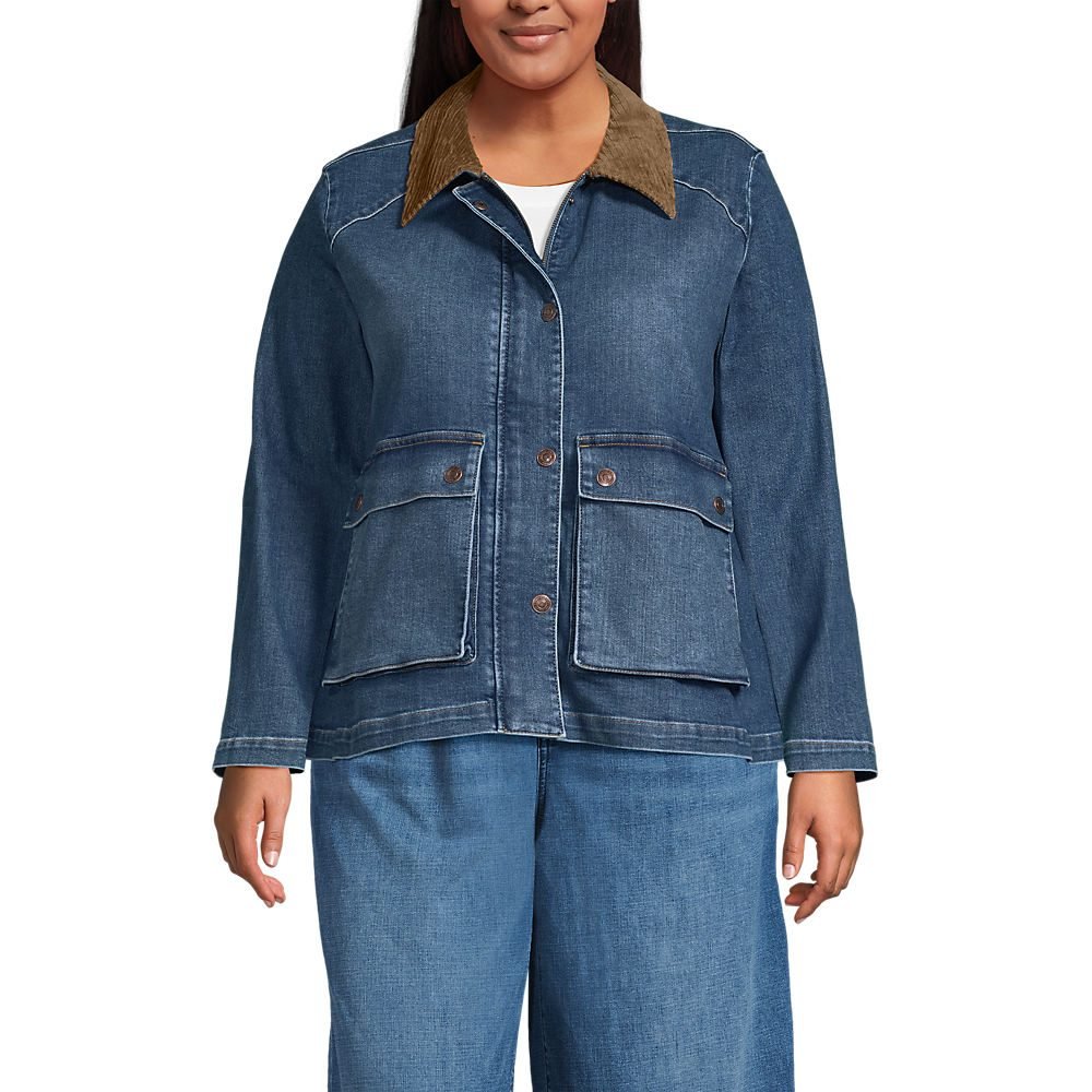 Woman over 50 wearing an indigo denim jacket over a burgundy cashmere sweater with white jeans.